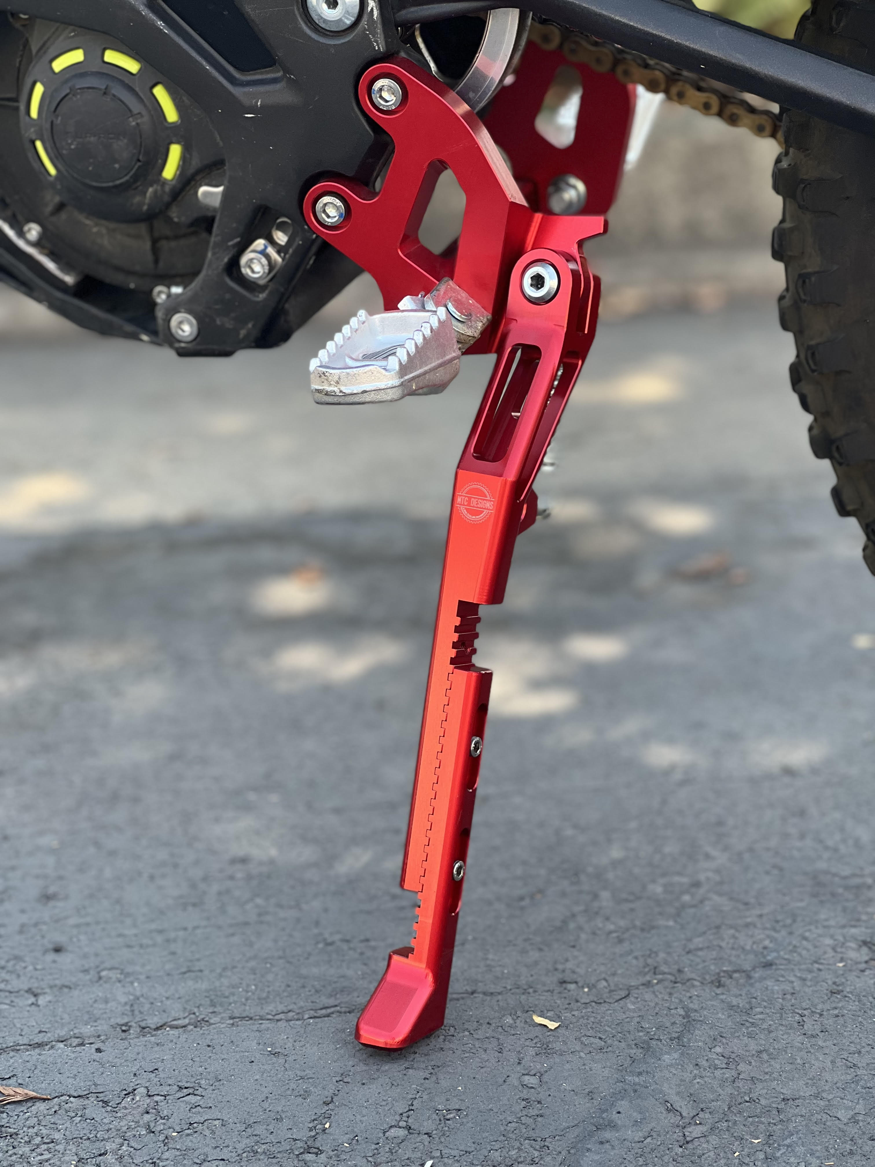 Surron Bike Upgrades Bundle - Red - 20mm Lowering Peg Brackets, Ignition Key Plate, Shark Fin Disc Guard and Standard Adjustable Kickstand.